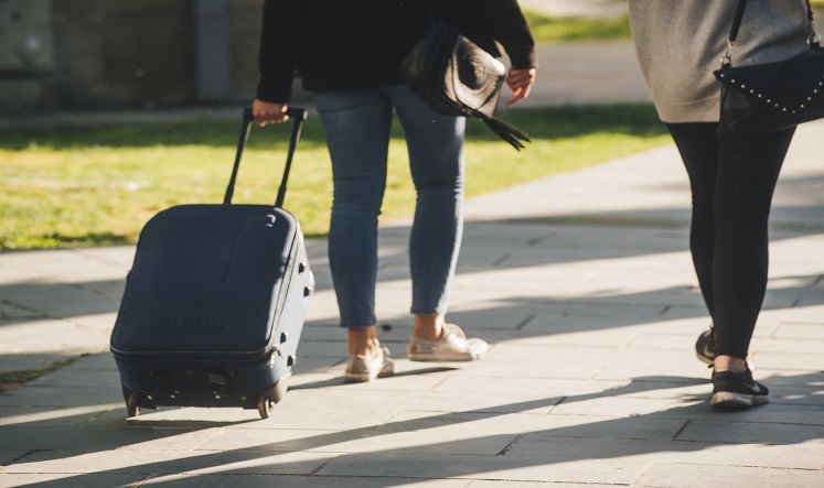Picture of two people with a suitcase